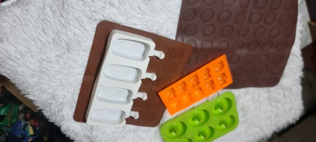 Take all Silicone Molds for Baking and Crafts (Category: Bakeware) located in Marikina City. Submitted by andreah_16 (Listing ID 1424295686, Image 1). Description: Set of silicone molds in various shapes. Includes molds for donuts, small squares, popsicle shapes, and a round patterned mat. Perfect for baking treats or crafting with resin or other materials. The molds are in different colors, offering versatility for your projects. Easy to clean a