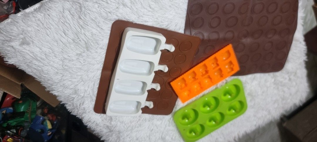 Take all Silicone Molds for Baking and Crafts (Category: Bakeware) located in Marikina City. Submitted by andreah_16 (Listing ID 1424295686, Image 2). Description: Set of silicone molds in various shapes. Includes molds for donuts, small squares, popsicle shapes, and a round patterned mat. Perfect for baking treats or crafting with resin or other materials. The molds are in different colors, offering versatility for your projects. Easy to clean a