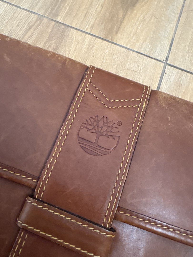 Timberland Leather Laptop / Document /Art Holder (Category: Laptop Bags & Sleeves) located in Imus. Submitted by _declutterby (Listing ID 1424202241, Image 2). Description: - Genuine Timberland leather laptop sleeve - Rare vintage. 1980s. - Brown exterior with flap closure - Features Timberland logo - Yellow lined interior - Includes zippered pocket and multiple compartments - Made in Italy - Snap closure - Well-constructed.