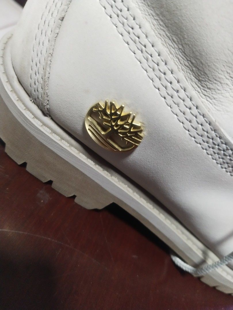 Timberland Women's Boots (Category: Boots) located in Manila. Submitted by surefwear (Listing ID 1424259495, Image 2). Description: - Light grey Timberland boots - Iconic Timberland logo - Lace-up design with gold eyelets - ReBOTL interior - Durable rubber sole - Made in Bangladesh.