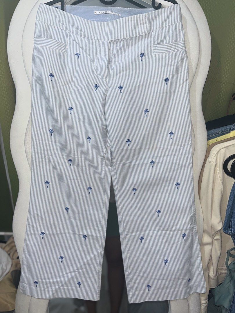 Tommy Hilfiger striped palm tree cropped pants (Category: Jeans) located in Valenzuela. Submitted by marinnette84771 (Listing ID 1424240039, Image 1). Description: Tommy Hilfiger pants Blue and white striped pattern Palm tree embroidery Wide leg cut Size 4/ 32 inch Button and zipper closure Cotton fabric Bought from Ireland orig price is 4k in php ps. not visible sa malayo yung mantsa rfs. decluttering .