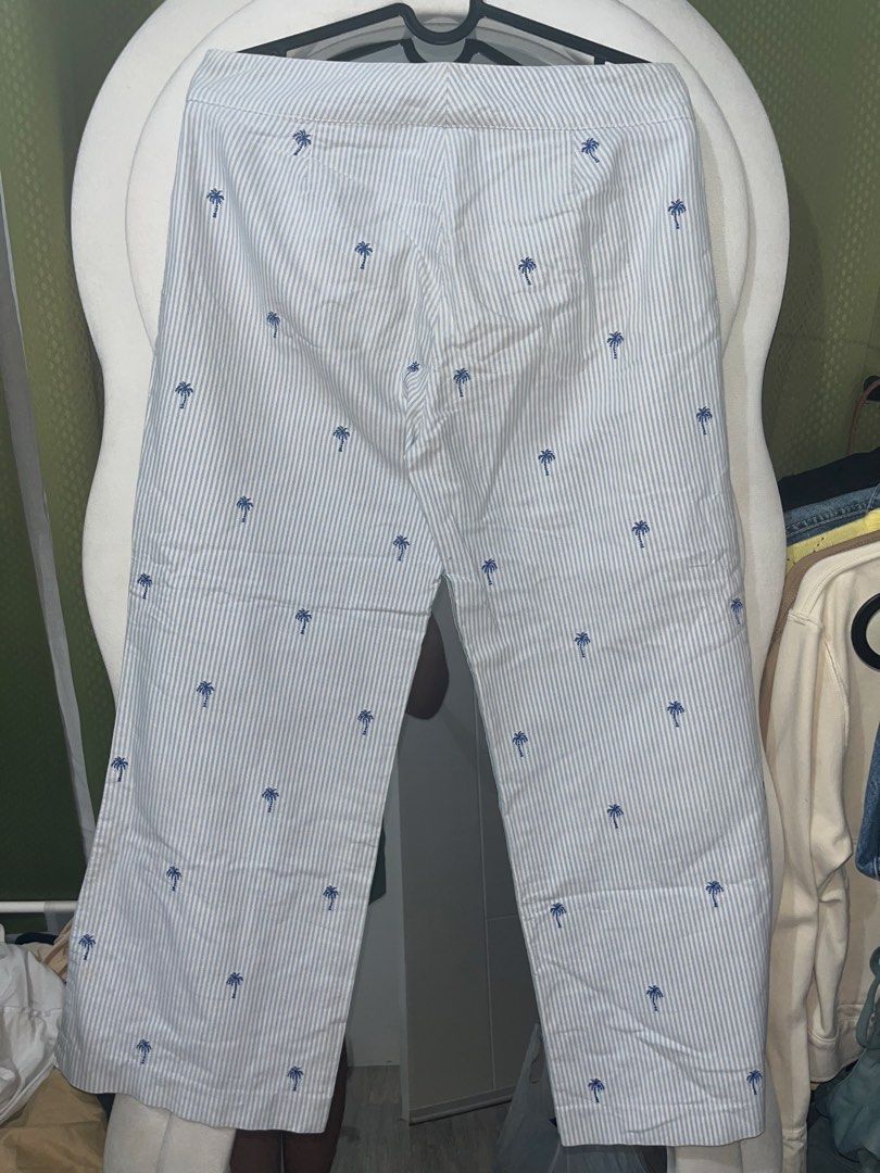 Tommy Hilfiger striped palm tree cropped pants (Category: Jeans) located in Valenzuela. Submitted by marinnette84771 (Listing ID 1424240039, Image 2). Description: Tommy Hilfiger pants Blue and white striped pattern Palm tree embroidery Wide leg cut Size 4/ 32 inch Button and zipper closure Cotton fabric Bought from Ireland orig price is 4k in php ps. not visible sa malayo yung mantsa rfs. decluttering .