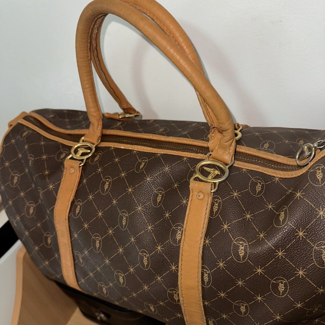 Trussardi Brown Duffle Bag (Category: Luxury Bags & Wallets) located in Mandaluyong City. Submitted by TheWeekendProject (Listing ID 1424200412, Image 2). Description: - Trussardi Brown Duffle Bag - Unisex design - Features the iconic Trussardi pattern - Ideal for travel - Classic brown color - Rubs visible on edges.