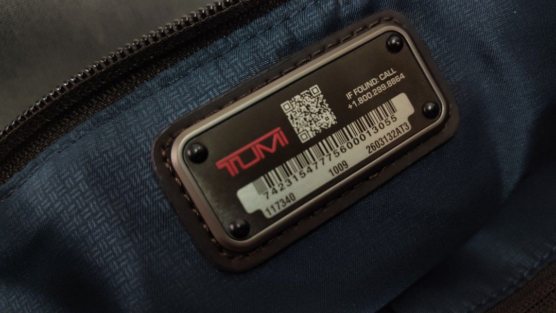 Tumi Briefcase anthracite (Category: Briefcases) located in Quezon City. Submitted by edwinvuru (Listing ID 1424196675, Image 3). Description: - Tumi briefcase - Sleek dark grey exterior with brown leather accents - Multiple compartments for organization - Padded interior - Detachable shoulder strap - Secure zipper closure - Includes luggage tag - Features metal Tumi logo.