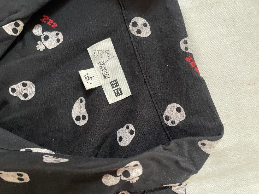 Uniqlo Studio Ghibli Pajama Top (Category: Undergarments & Loungewear) located in Cainta. Submitted by anne_garagesale (Listing ID 1424185174, Image 2). Description: - Studio Ghibli collaboration pajama top - Black color - Features a repeating pattern of white skull-like characters with red accents - Button-down front - Collared neckline - Size: Large - Made in China.