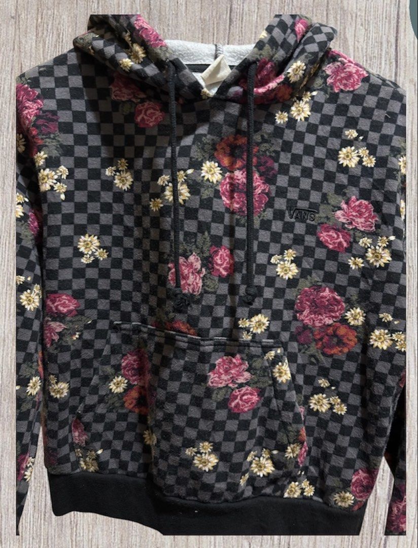 Vans Floral Checkered Hoodie (Category: Coats, Jackets and Outerwear) located in Manila. Submitted by aj-thrifter (Listing ID 1424335198, Image 3). Description: Vans hoodie features a unique floral and checkered pattern. It has a front pocket and a drawstring hood. The cuffs and hem are black. The Vans logo is visible on the front. The tag indicates the material composition. Dimension is 20/20z .
