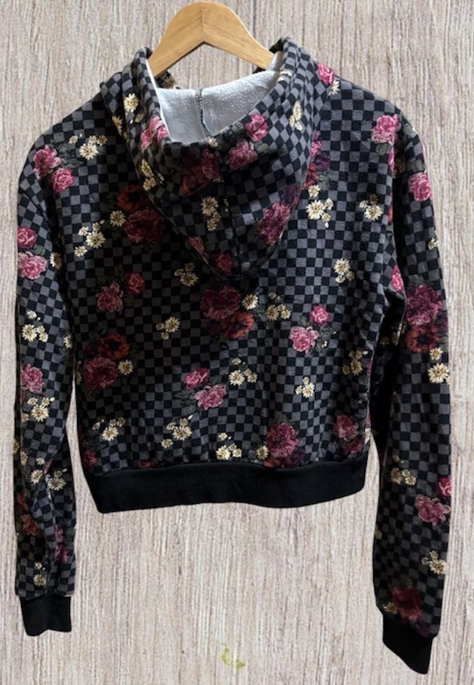 Vans Floral Checkered Hoodie (Category: Coats, Jackets and Outerwear) located in Manila. Submitted by aj-thrifter (Listing ID 1424335198, Image 2). Description: Vans hoodie features a unique floral and checkered pattern. It has a front pocket and a drawstring hood. The cuffs and hem are black. The Vans logo is visible on the front. The tag indicates the material composition. Dimension is 20/20z .