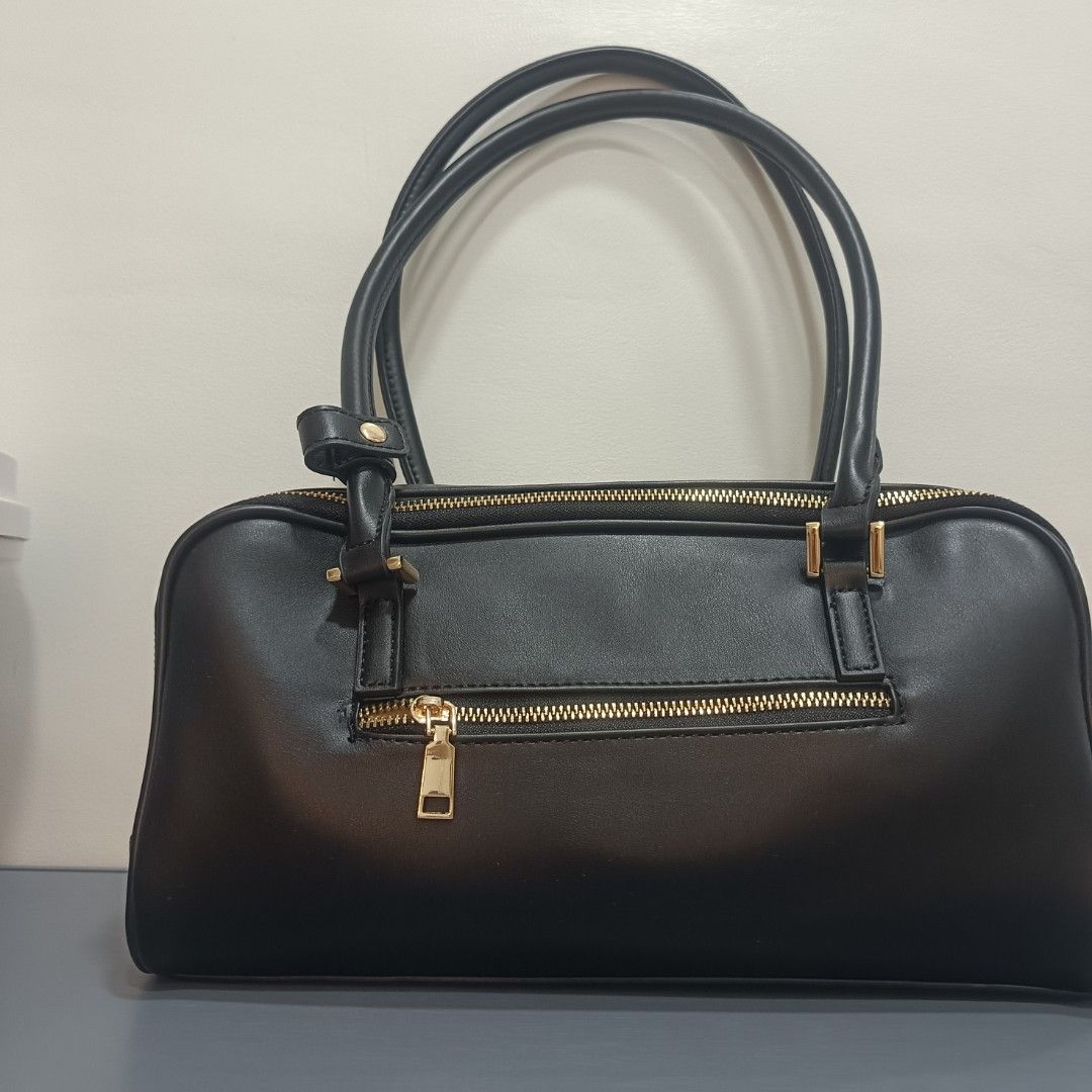 Vegan Confessions Black Handbag (Category: Luxury Bags & Wallets) located in Dagupan City. Submitted by nmcmp4 (Listing ID 1424237165, Image 2). Description: - Black handbag from Vegan Confessions - Rectangular shape - Double handles - Gold-colored zippers - Includes small bear plushie - Made of smooth, leather-like material - Simple and elegant design - No box - Suitable for everyday use.
