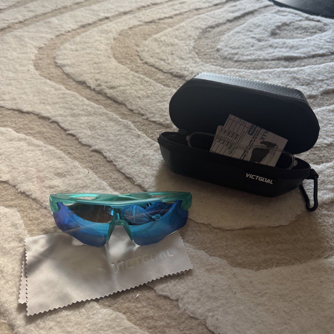 Victgoal Blue Sports Sunglasses VA312 (Category: Sunglasses & Eyewear) located in Makati City. Submitted by finders.keep.hers (Listing ID 1424258521, Image 2). Description: - Victgoal sports sunglasses - Blue-tinted lenses - Teal frame - Model: VA312 - Includes hard case with zipper closure and Victgoal logo - Comes with cleaning cloth and paperwork - Designed for sports activities.