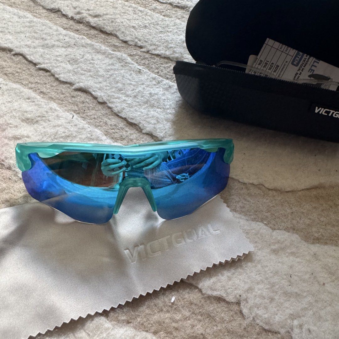 Victgoal Blue Sports Sunglasses VA312 (Category: Sunglasses & Eyewear) located in Makati City. Submitted by finders.keep.hers (Listing ID 1424258521, Image 1). Description: - Victgoal sports sunglasses - Blue-tinted lenses - Teal frame - Model: VA312 - Includes hard case with zipper closure and Victgoal logo - Comes with cleaning cloth and paperwork - Designed for sports activities.