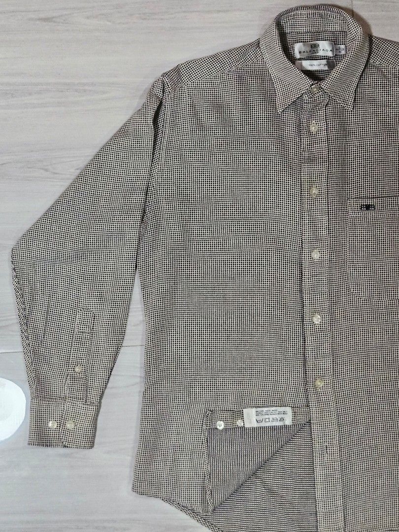 Vintage Balenciaga Checkered Button Down Shirt (Category: Tshirts & Polo Shirts ) located in Candon. Submitted by itssummer08 (Listing ID 1424217231, Image 2). Description: - Balenciaga long sleeve shirt - Checkered pattern - Button-down closure - Chest pocket - Made of 100% cotton - Size: 14-3/4 32 - Care instructions: Machine wash warm, tumble dry low, no bleach L 28in W 20.5in fit to S-M.