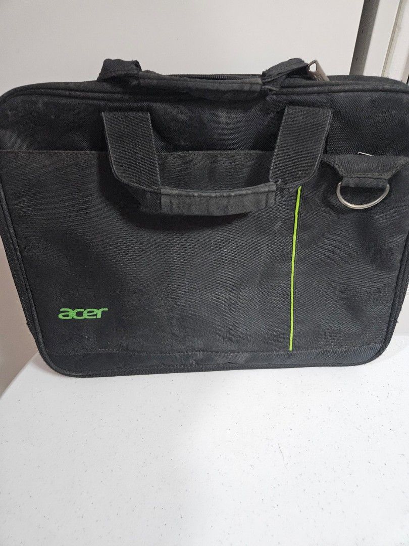 Acer Laptop Bag with Green Interior (Category: Laptop Bags & Sleeves) located in Caloocan City. Submitted by rm.diaz (Listing ID 1427549418, Image 3). Description: Black laptop bag with a green interior. Features a handle and a shoulder strap attachment point. The bag has multiple compartments inside for organization. The Acer logo is visible on the front..
