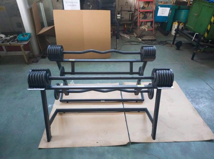 Adjustable Fixed Barbell (Category: Weights & Dumbbells) located in Caloocan City. Submitted by protein888 (Listing ID 1427625678, Image 3). Description: Adjustable barbell set from BYZOOA includes two barbells and weight plates. The weight plates are adjustable, allowing for varied resistance levels. The set comes with a stand for easy storage and organization. The barbells have both straight and curved bars..