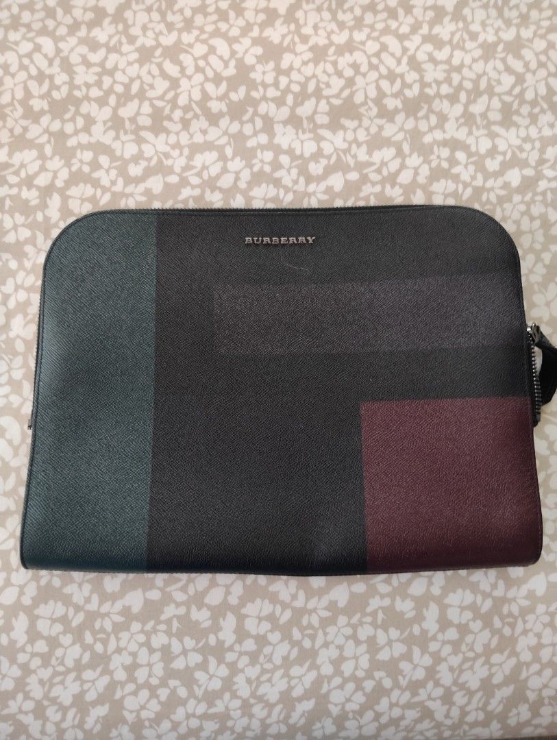 Burberry Clutch /Laptop Bag (Category: Luxury Bags & Wallets) located in Manila. Submitted by dcsago (Listing ID 1427489142, Image 2). Description: - Burberry Clutch / Laptop Bag - Unisex design - Features a modern color-block pattern - Includes the iconic Burberry check lining - Stylish and functional.