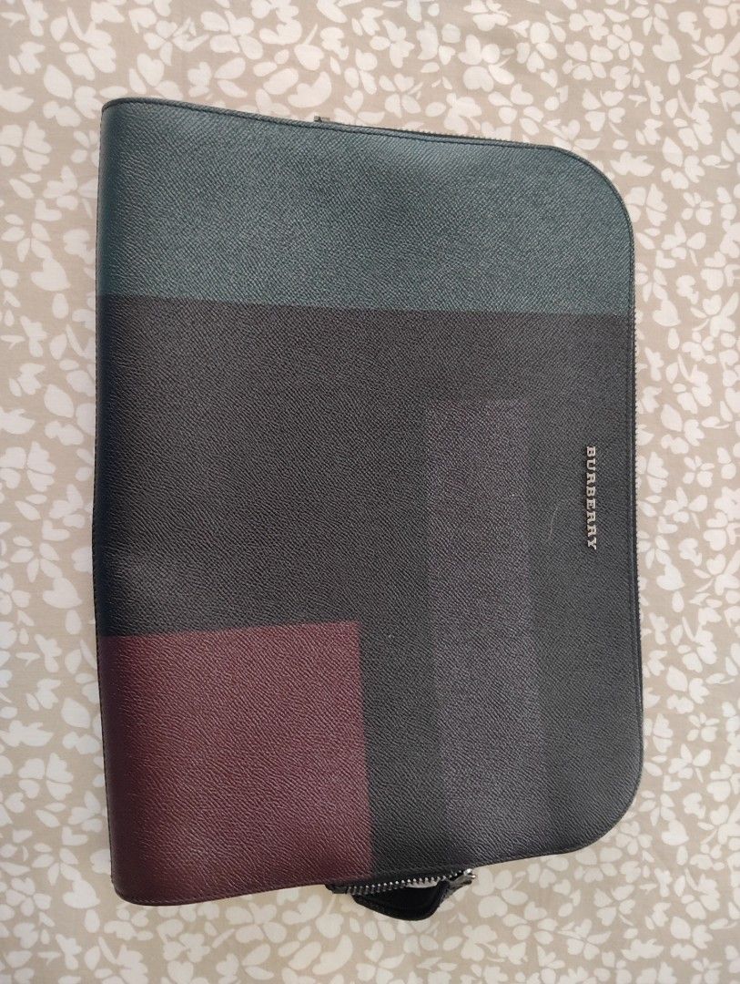 Burberry Clutch /Laptop Bag (Category: Luxury Bags & Wallets) located in Manila. Submitted by dcsago (Listing ID 1427489142, Image 1). Description: - Burberry Clutch / Laptop Bag - Unisex design - Features a modern color-block pattern - Includes the iconic Burberry check lining - Stylish and functional.