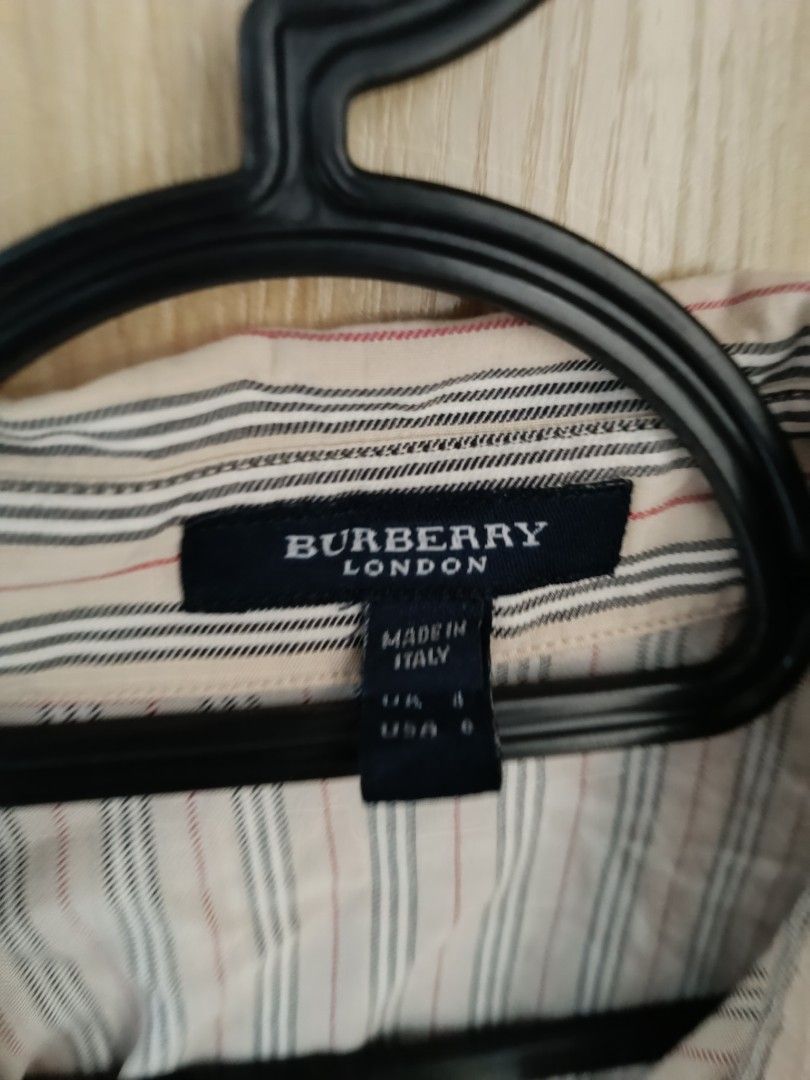 Burberry London Striped blouse (Category: Longsleeves) located in Trece Martires City. Submitted by declutterbyedi (Listing ID 1427608413, Image 2). Description: Burberry London striped shirt. Made in Italy. Features a collared neckline and button-down closure. The shirt has three-quarter sleeves. The size is UK 6 and USA 4. The shirt has a classic striped pattern with neutral colors..
