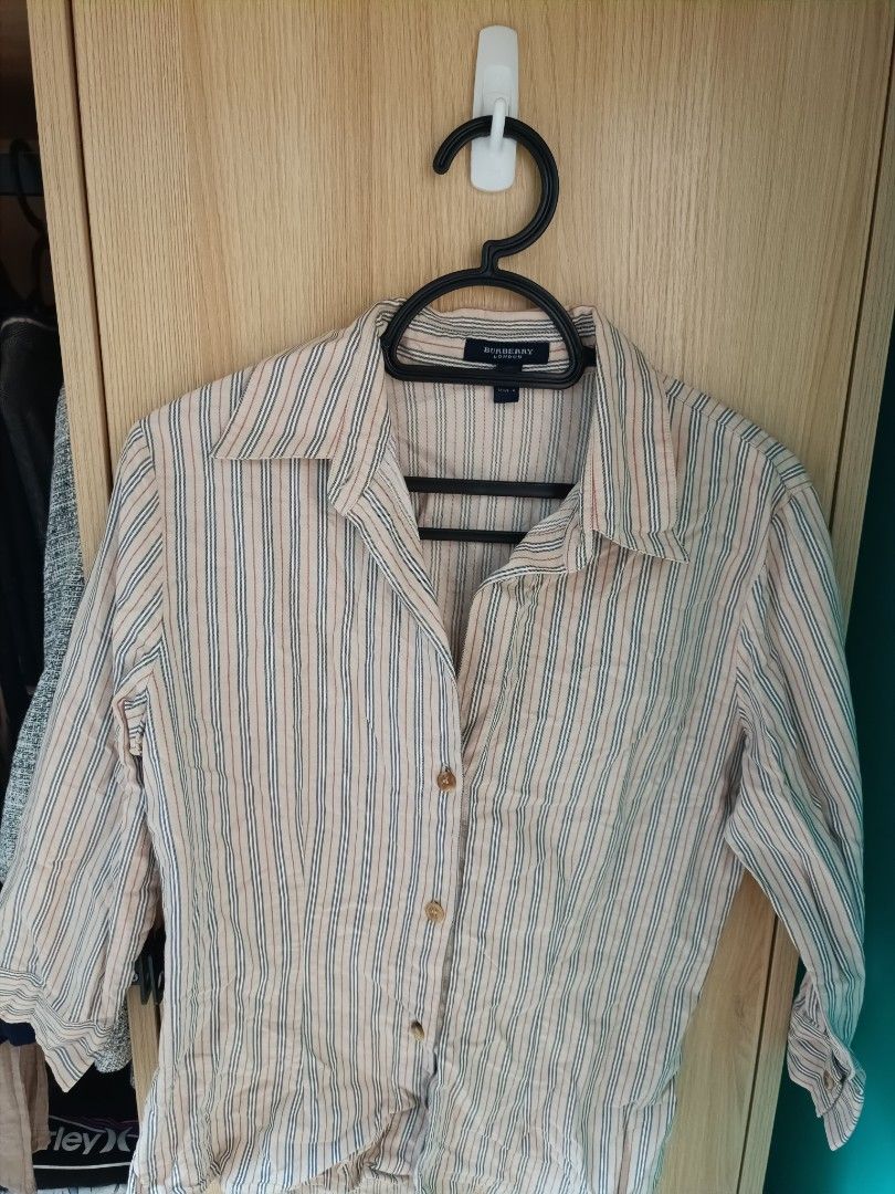 Burberry London Striped blouse (Category: Longsleeves) located in Trece Martires City. Submitted by declutterbyedi (Listing ID 1427608413, Image 1). Description: Burberry London striped shirt. Made in Italy. Features a collared neckline and button-down closure. The shirt has three-quarter sleeves. The size is UK 6 and USA 4. The shirt has a classic striped pattern with neutral colors..