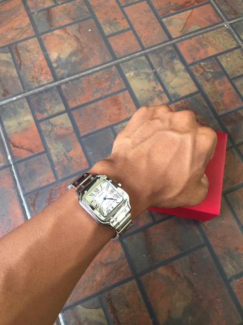 Cartier Santos Galbee Watch (Category: Luxury Watches) located in Manila. Submitted by jaydrenn (Listing ID 1427525911, Image 1). Description: Elegant Cartier Santos Galbee watch with a silver-tone stainless steel bracelet and case. Features a white dial with Roman numeral hour markers and blue hands. Includes the original red Cartier box. The watch has a square case shape and a secure clasp. A stylish accessory for any occasion..