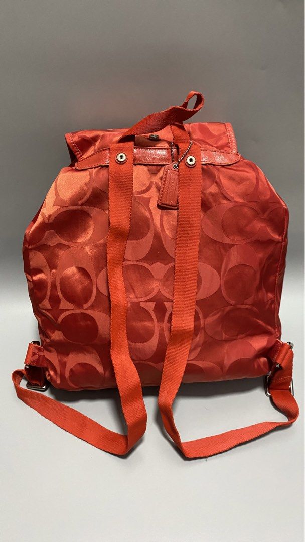 Coach Signature Backpack (Category: Luxury Bags & Wallets) located in Manila. Submitted by owabaet12 (Listing ID 1427633508, Image 3). Description: Coach backpack features a signature pattern in a vibrant orange color. It has a drawstring closure and adjustable straps. The backpack includes a Coach logo emblem. The design includes a flap closure and a small leather tag..