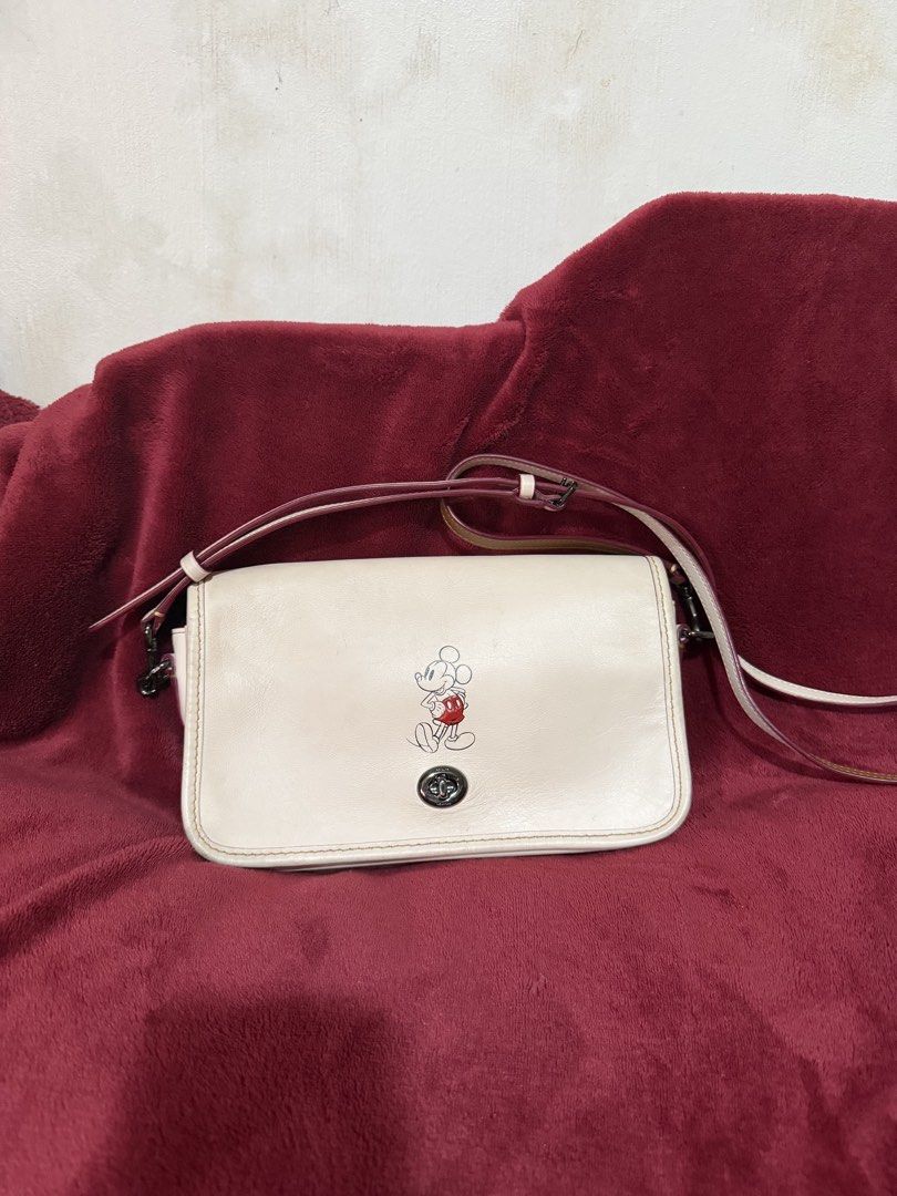 Coach x Disney Collab crossbody bag (Category: Cross-body Bags) located in San Pablo. Submitted by prelovedbymistyblue (Listing ID 1427558274, Image 1). Description: Original coach collab with disney crossbody bag. No major flaws except minimal signs of use on the leather and minimal dirt. No hangtag included. Belt type removable sling. Measures 8.5 x 5.5 x 1.8 inches. Selling low for 3000, down to 2600. .