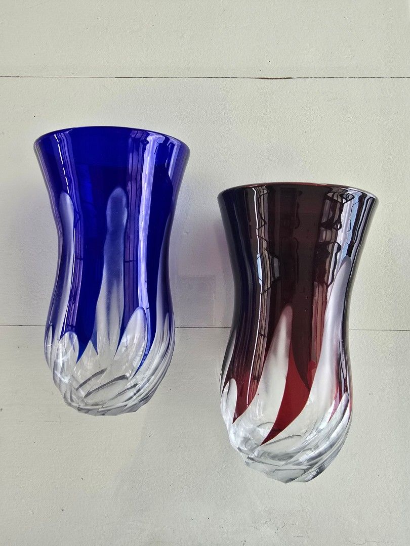 Colored Glass Vases (Category: Vases & Decorative Bowls) located in Taguig. Submitted by threadsntable (Listing ID 1398811188, Image 1). Description: - Set of two glass vases - One blue, one red - Unique swirling design - Flared top and sturdy base - Ideal for flowers or decoration.