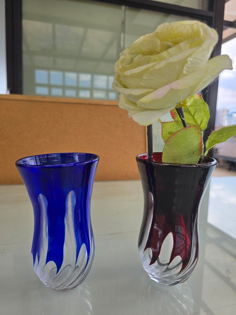 Colored Glass Vases (Category: Vases & Decorative Bowls) located in Taguig. Submitted by threadsntable (Listing ID 1398811188, Image 3). Description: - Set of two glass vases - One blue, one red - Unique swirling design - Flared top and sturdy base - Ideal for flowers or decoration.