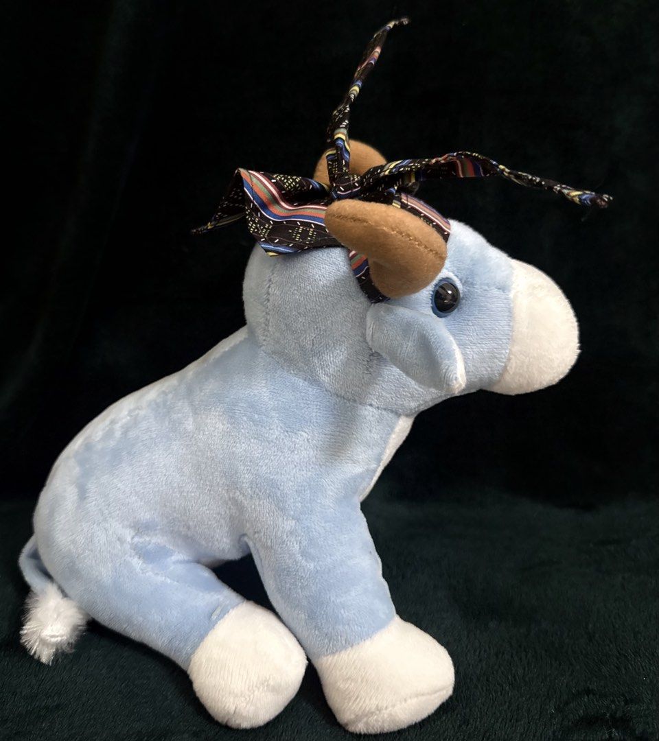 Conrad Manila Plush Cow (Category: Plushies & Soft Toys) located in Pasay City. Submitted by addtocartacademy (Listing ID 1427614099, Image 3). Description: Adorable plush cow is from Conrad Manila. It features a light blue body with white accents on the face, feet, and tail. The cow has brown horns and a patterned headpiece. The Conrad Manila logo is embroidered on the chest. It's a cute and cuddly collectible item..