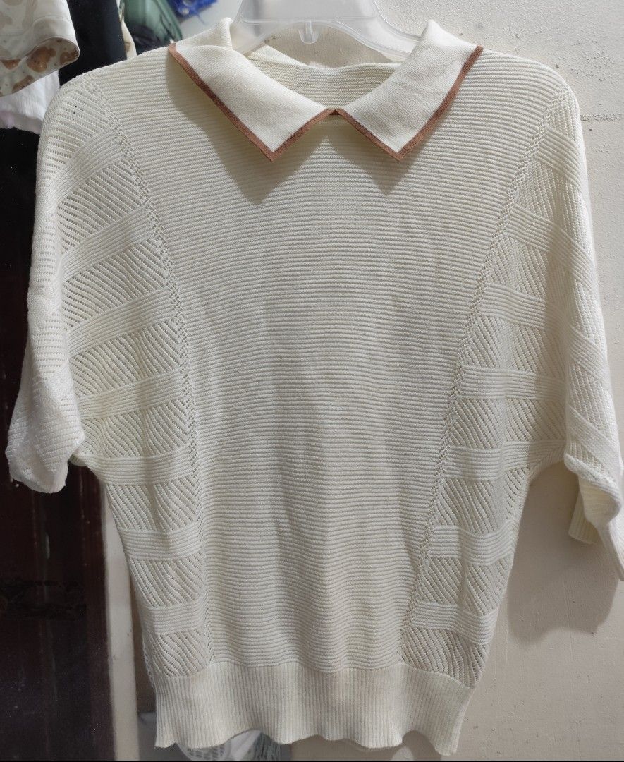 Cream-colored Sweater with Brown Collar (Category: Longsleeves) located in Quezon City. Submitted by melsc (Listing ID 1427544889, Image 1). Description: Cream-colored sweater features a unique design with a brown-trimmed collar. It has short sleeves and a textured knit pattern on the sleeves and body. It's a versatile piece that can be dressed up or down..