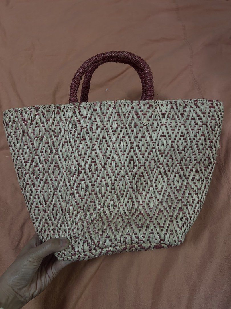 Embroidered Butterfly Straw Handbag (Category: Beach Bags) located in Manila. Submitted by treenitea (Listing ID 1427509107, Image 2). Description: Straw handbag features an intricate butterfly embroidery design. It has a woven texture with a red and beige color scheme. The bag includes a pair of handles and a drawstring closure. The interior is lined with a dark red fabric. It's a stylish accessory for everyday use..