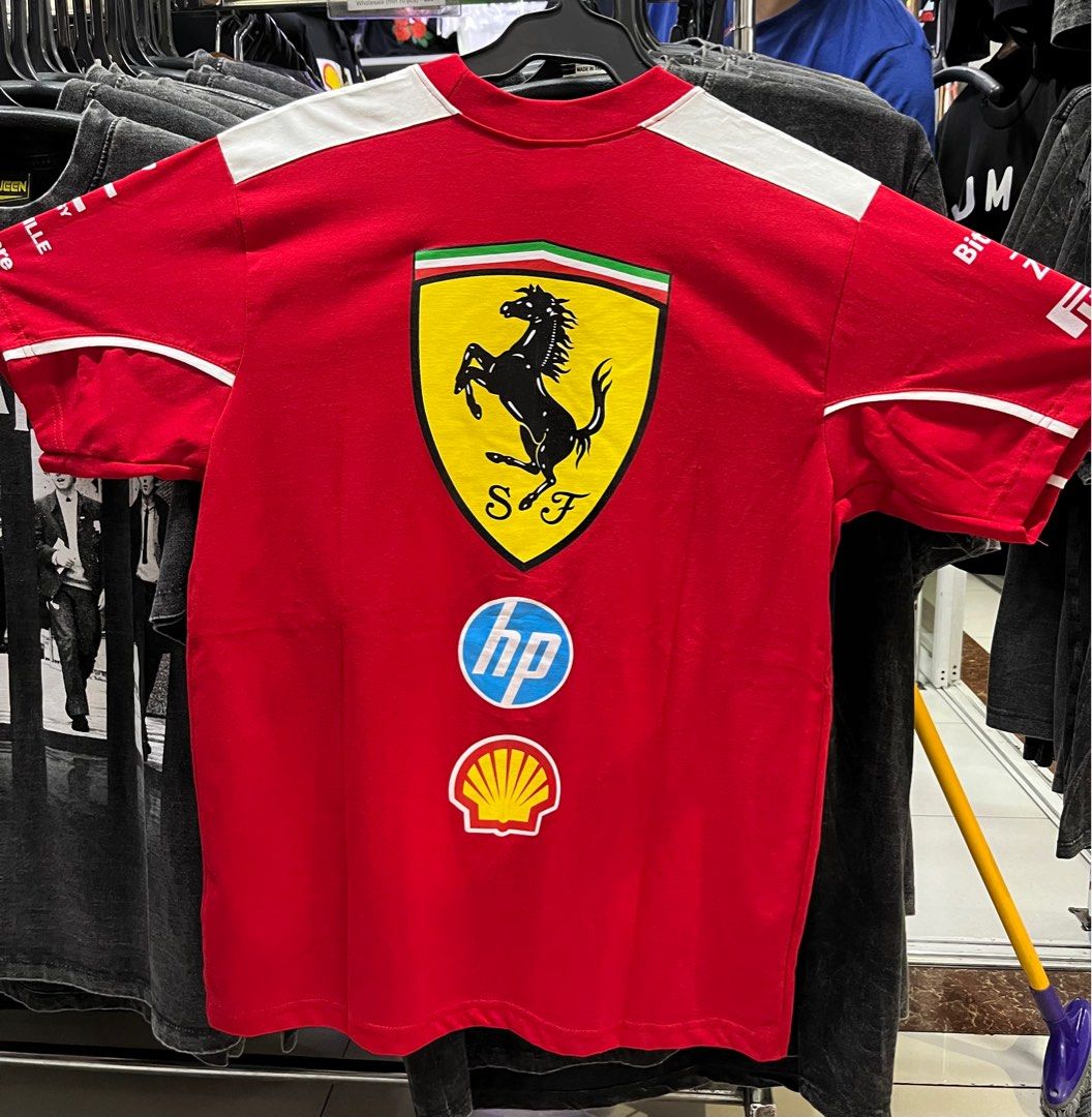 Ferrari Racing T-shirt - Red (Category: Tshirts & Polo Shirts ) located in Antipolo. Submitted by _lprpnzz (Listing ID 1427572674, Image 2). Description: Red Ferrari racing t-shirt. Features the Ferrari logo on the front and back. Includes sponsor logos such as HP, Shell, and Bridgestone. The shirt has white accents on the sleeves and sides. It has a crew neck and short sleeves..