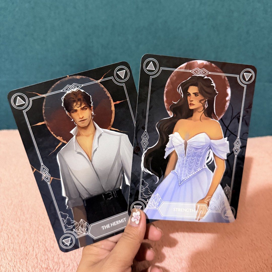 FL Book Merch - Strength & The Hermit Cards (Category: Storybooks) located in Santa. Submitted by thefolklore (Listing ID 1427600416, Image 1). Description: COLLECTIBLE OF THE MONTH DESIGNED BY @AVENDELLART This month’s tarot card set features Alissa as the Strength card, and Keil as The Hermit card. The characters are from Thorn Season by Kiera Azar..