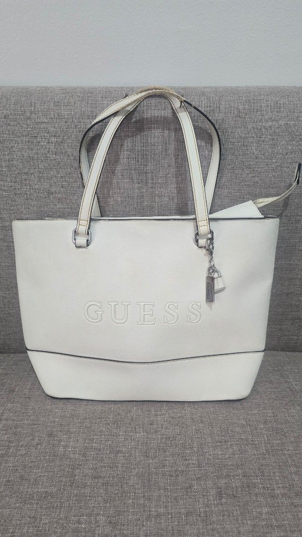 Guess White Tote Bag (Category: Tote Bags) located in Quezon City. Submitted by k8_wallace (Listing ID 1427498771, Image 1). Description: Nice and sturdy bag. It was gifted a couple of years ago. Spacious interior. Authentic Flaws: Leather trim on handle peeling off Dirt on surface. Stain from clothing at the back of the bag. All sales are final. GCash or BPI payments only.