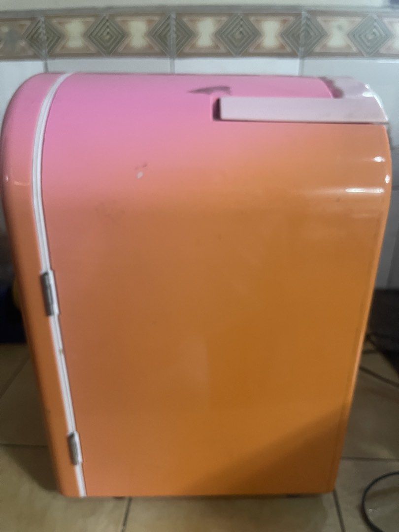 Hello Kitty Mini Fridge 110v / 12dc (Category: Refrigerators and Freezers) located in Manila. Submitted by chesterson1979. (Listing ID 1427524547, Image 2). Description: Adorable Kitty mini fridge. Features both hot and cold modes. It has a 100V and 12V power input. The fridge has a shelf inside. The exterior is pink with a Kitty design on the front. It has a handle and a door that opens. The back has a vent and power input..