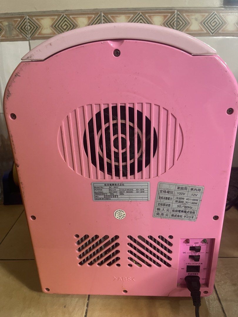 Hello Kitty Mini Fridge 110v / 12dc (Category: Refrigerators and Freezers) located in Manila. Submitted by chesterson1979. (Listing ID 1427524547, Image 3). Description: Adorable Kitty mini fridge. Features both hot and cold modes. It has a 100V and 12V power input. The fridge has a shelf inside. The exterior is pink with a Kitty design on the front. It has a handle and a door that opens. The back has a vent and power input..
