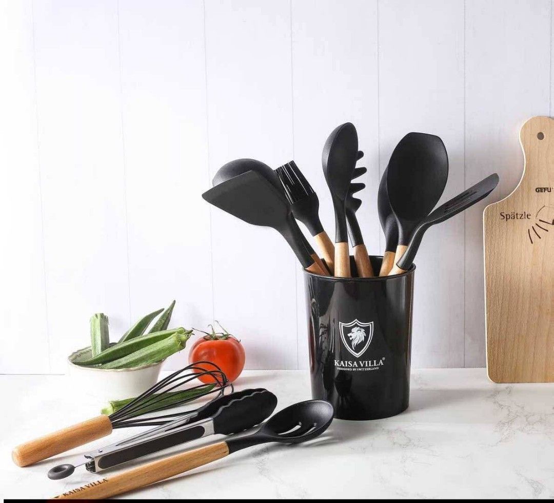 Kaisa Villa Kitchen Utensil Set (Category: Other Kitchenware & Tableware) located in Manila. Submitted by haideshop (Listing ID 1427608028, Image 2). Description: Complete your kitchen with this Kaisa Villa utensil set. It includes various tools like spoons, spatulas, a whisk, tongs, and more. The utensils have black heads and wooden handles. A black container is also included for storage. Perfect for everyday cooking needs..