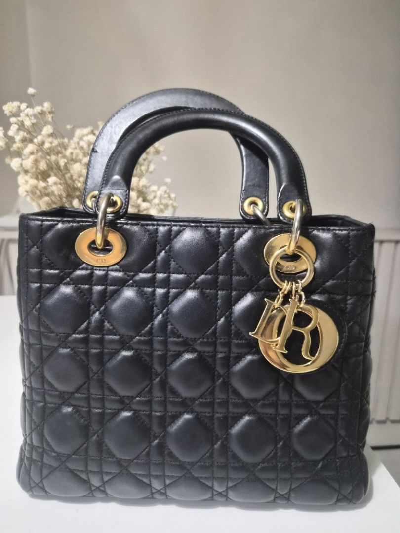 Lady Dior Medium (Category: Luxury Bags & Wallets) located in Manila. Submitted by fasyon (Listing ID 1261921151, Image 2). Description: authentic color black gold hardware with dustbag, insert organizer, and entrupy certificate no damage or major flaws hardware on the straps have faded but overall still looks good there are signs of wear and tear.