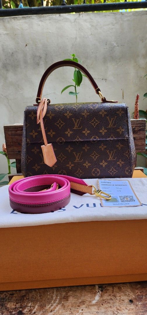 Louis Vuitton clunny (Category: Luxury Bags & Wallets) located in San Ildefonso. Submitted by chelsea_manalang42 (Listing ID 1427524396, Image 1). Description: Authentic Louis Vuitton Dauphine Mini handbag. Features the iconic Monogram canvas with a pink interior. Includes a detachable pink shoulder strap and a top handle. Comes with an Entrupy certificate of authenticity. The bag has a gold-tone hardware and a flap closure. Includes the original