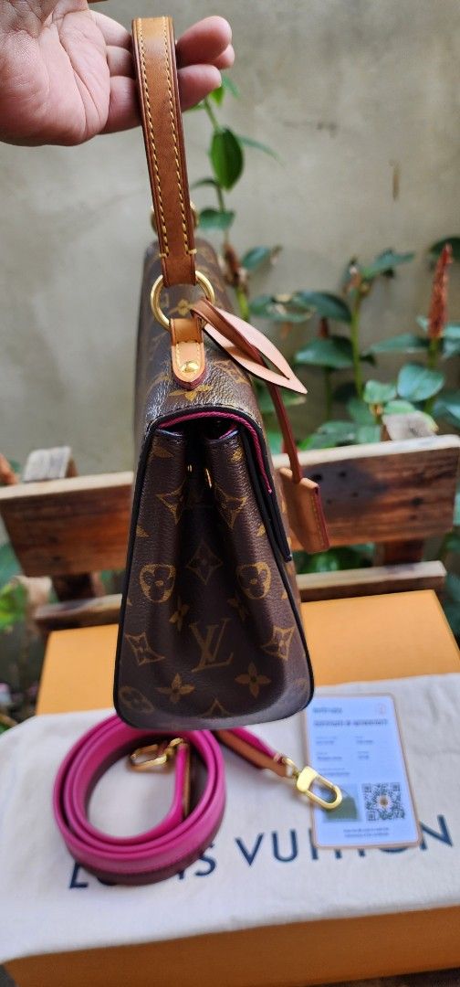 Louis Vuitton clunny (Category: Luxury Bags & Wallets) located in San Ildefonso. Submitted by chelsea_manalang42 (Listing ID 1427524396, Image 2). Description: Authentic Louis Vuitton Dauphine Mini handbag. Features the iconic Monogram canvas with a pink interior. Includes a detachable pink shoulder strap and a top handle. Comes with an Entrupy certificate of authenticity. The bag has a gold-tone hardware and a flap closure. Includes the original