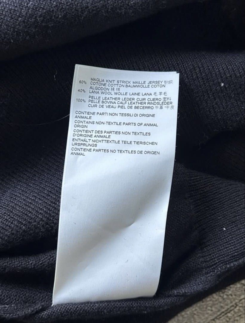 Maison Margiela Black Cardigan (Category: Coats, Jackets and Outerwear) located in Tarlac. Submitted by ae01019x (Listing ID 1427519154, Image 3). Description: Black cardigan from Maison Margiela. Features a V-neck and button closure. Made in Romania. Size L. Fabric composition: 60% Maglia Knit, 40% Wool. Includes care instructions. The item has the Maison Margiela label with the number 14..