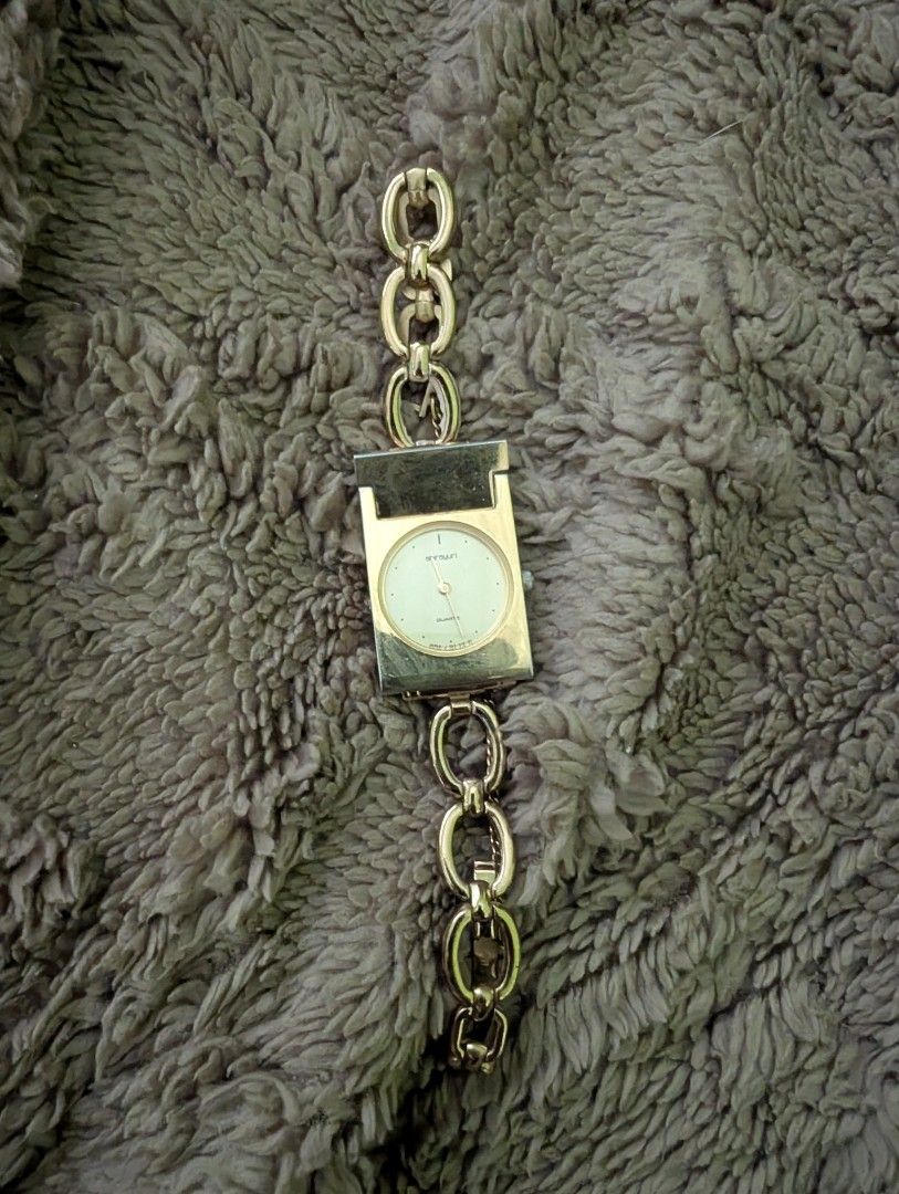 Menard Quartz Watch EGP 565040 (Category: Women's Watches) located in Muntinlupa City. Submitted by luckyfrogzone (Listing ID 1427517371, Image 1). Description: Elegant Menard quartz watch with a gold-toned rectangular face and matching chain-link strap. The watch face is a light cream color with gold hands and markers. The back of the watch is marked with "Menard" and "EGP Back Stainless Steel". The watch is marked "Japan E"..