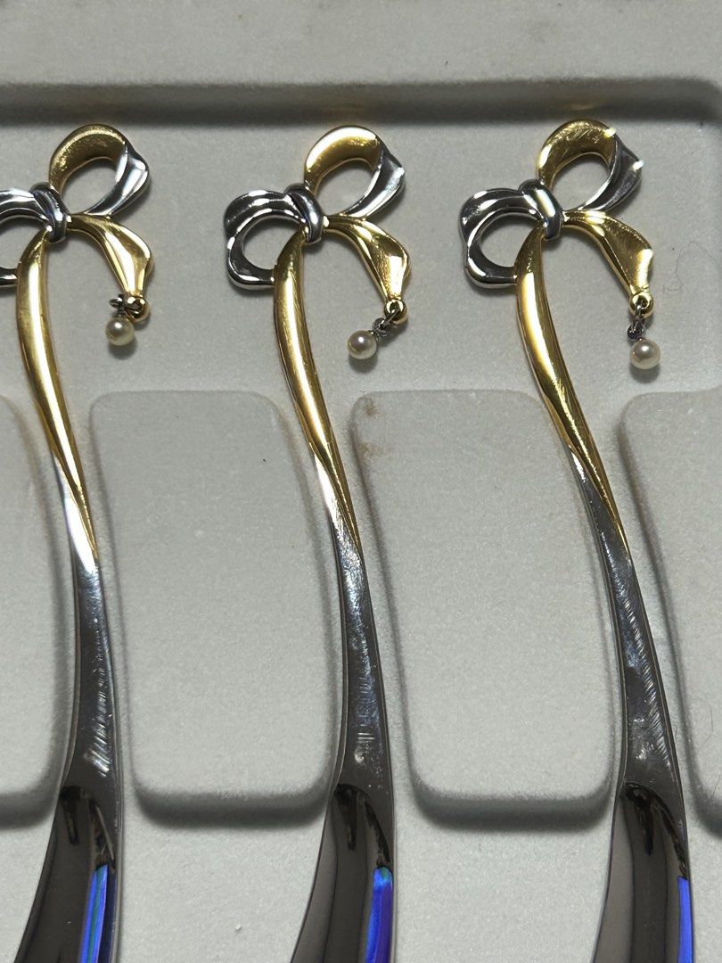 Bo26Mikimoto Spoon Set with Pearl (Category: Dinnerware & Cutlery) located in Angeles City. Submitted by zyeplustradings (Listing ID 1427605264, Image 2). Description: Elegant Mikimoto spoon set. Features a bow design with a small pearl pendant. The spoons have a gold and silver color scheme. The set comes in its original box. The spoons are marked with "MIKIMOTO 18-8"..