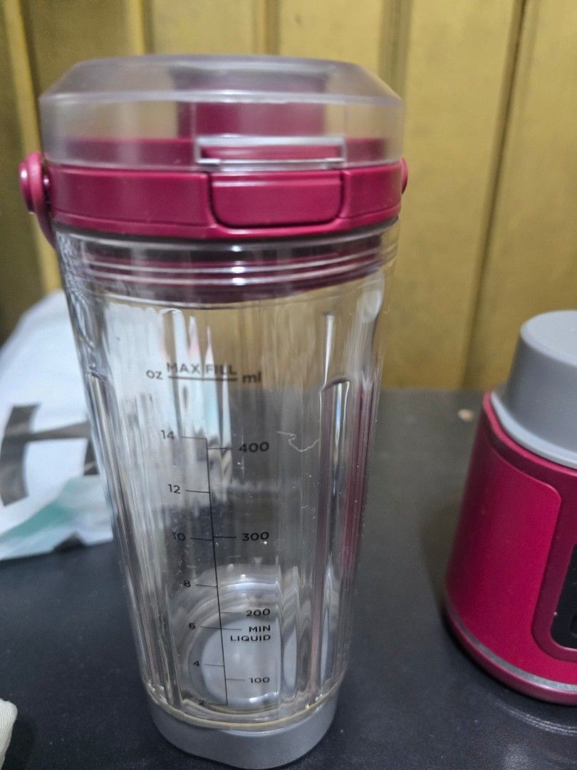 Ninja Personal Blender (Category: Juicers, Blenders & Grinders) located in Quezon City. Submitted by martinalejandrino (Listing ID 1427594220, Image 3). Description: Ninja personal blender. pink blender base with a start/stop button and a clear blending cup with a lid. The cup has measurement markings..