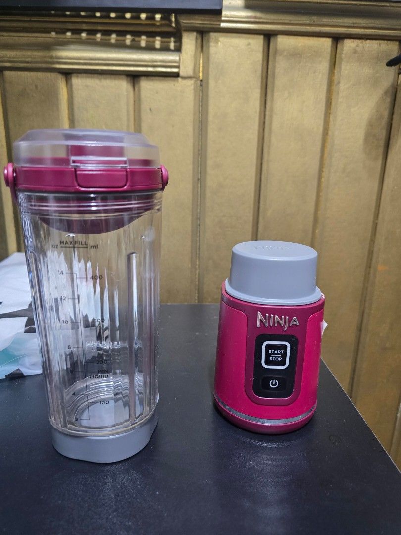 Ninja Personal Blender (Category: Juicers, Blenders & Grinders) located in Quezon City. Submitted by martinalejandrino (Listing ID 1427594220, Image 1). Description: Ninja personal blender. pink blender base with a start/stop button and a clear blending cup with a lid. The cup has measurement markings..
