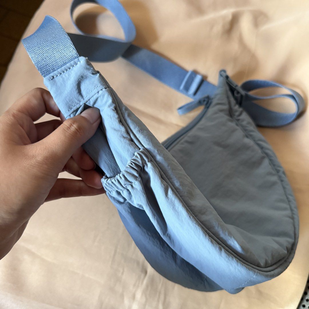Original Uniqlo Dumpling Bag in Blue (Category: Shoulder Bags) located in Antipolo. Submitted by bern.clo (Listing ID 1427518176, Image 2). Description: • blue in color • the latest version of the dumpling bag • adjustable straps • with side pocket • almost brand new (used only once).