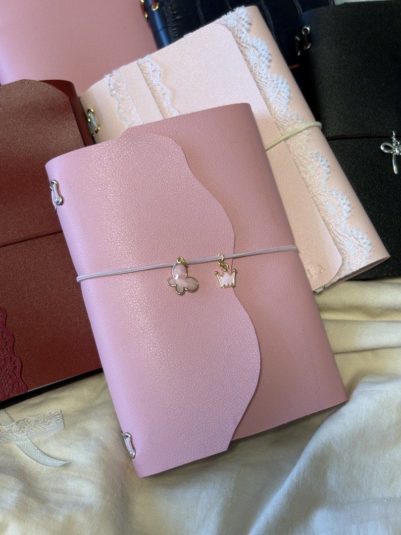 PERSONALIZED LEATHER JOURNAL FOR AS LOW AS 250 PESOS (Category: Stationery & School Supplies) located in Makati City. Submitted by dreamy.pagesph (Listing ID 1427575801, Image 2). Description: INCLUSIONS: • FAUX LEATHER FOLIO WITH 8 HOLES (CAN FIT UP TO 4 NOTEBOOKS) • GROMMETS • STRING CORD • 2 NOTEBOOKS • 1 CHARM • ENGRAVING (< 5 CHARACTERS FREE) BASE PRICE A6: • BIFOLD - 250 PHP • TRIFOLD - 280 PHP A5 • BIFOLD - 350 PHP • TRIFOLD - 380 PHP ADDI