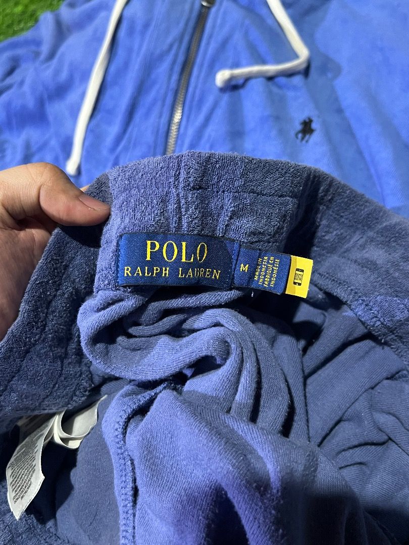Polo by Ralph Lauren Tracksuit (Category: Sets & Coordinates) located in Manila. Submitted by dbygotpaid (Listing ID 1427593680, Image 3). Description: Polo by Ralph Lauren tracksuit includes a blue zip-up hoodie and matching shorts. The hoodie features a small embroidered logo on the chest, a hood with drawstring, and a full-length zipper. The shorts also have the Polo logo. Both pieces appear to be made of a soft, terrycloth-like material. The 