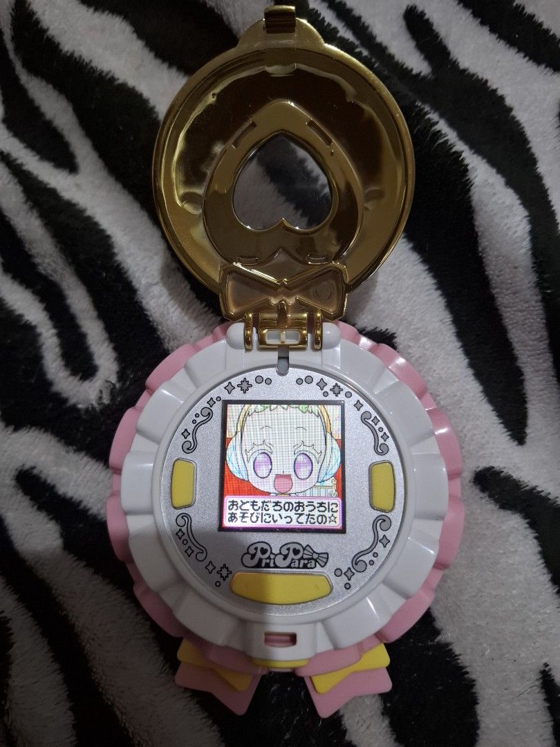 Pretty Cure Heart Compact like tamagotchi (Category: Interactive Toys) located in Cainta. Submitted by yuvunuueue (Listing ID 1427251245, Image 2). Description: Pretty Cure Heart Compact toy. It features a gold-colored heart-shaped locket like a tamagotchi .