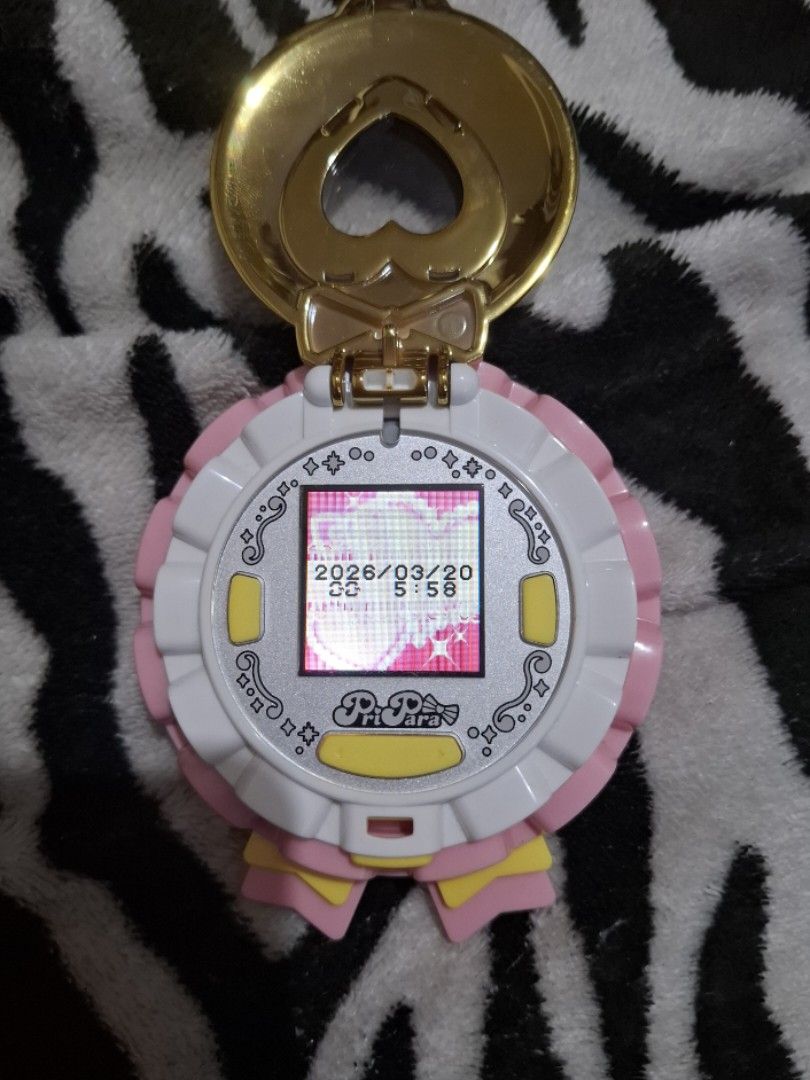 Pretty Cure Heart Compact like tamagotchi (Category: Interactive Toys) located in Cainta. Submitted by yuvunuueue (Listing ID 1427251245, Image 3). Description: Pretty Cure Heart Compact toy. It features a gold-colored heart-shaped locket like a tamagotchi .