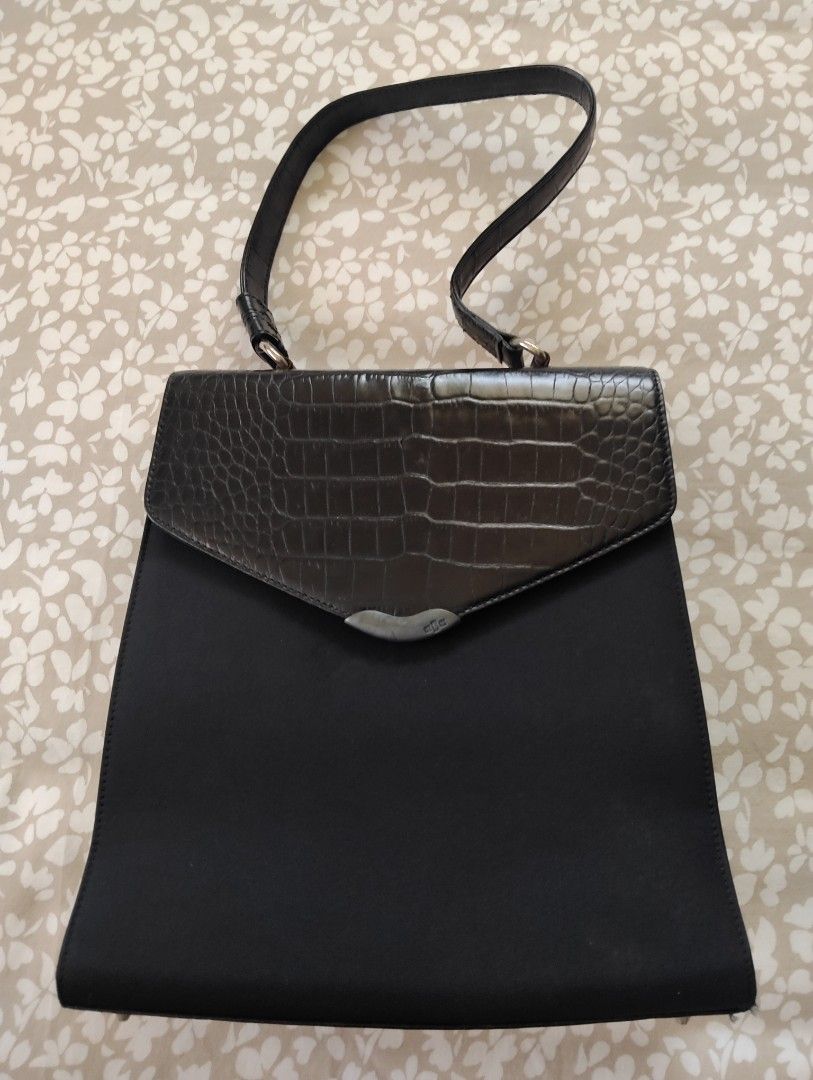Ralph Lauren Black Handbag (Category: Luxury Bags & Wallets) located in Manila. Submitted by dcsago (Listing ID 1427488637, Image 1). Description: Elegant black handbag by Ralph Lauren. Features a textured flap and a sleek, rectangular design. Includes a top handle and a secure closure. The interior has a zipper. The bag has a unique design element on the front. The bag is black..