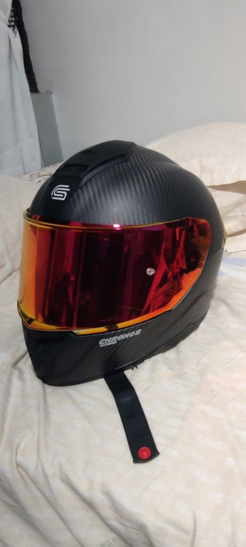 SEC Chronos Carbon Fiber Helmet (Category: Everything Else Others) located in Del Monte. Submitted by happytiger.f719df (Listing ID 1427617022, Image 1). Description: SEC Chronos helmet with a carbon fiber design. Features a red visor and a comfortable interior. The helmet has an ECE22-05 certification. Includes a chin strap with a red button. The helmet has a sleek, aerodynamic design. The interior padding is red and black..
